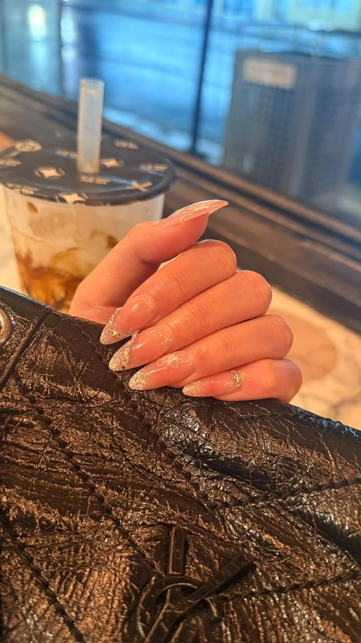 Nude almond nails with glitter tips